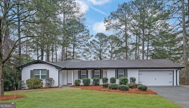 ranch-style home featuring a front yard and a garage