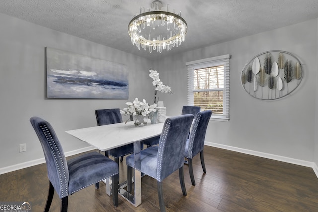 dining space featuring dark wood-type flooring, a chandelier, and a textured ceiling