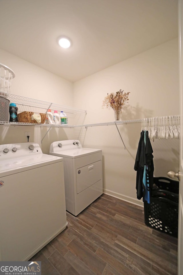 clothes washing area featuring washer and dryer and dark hardwood / wood-style floors