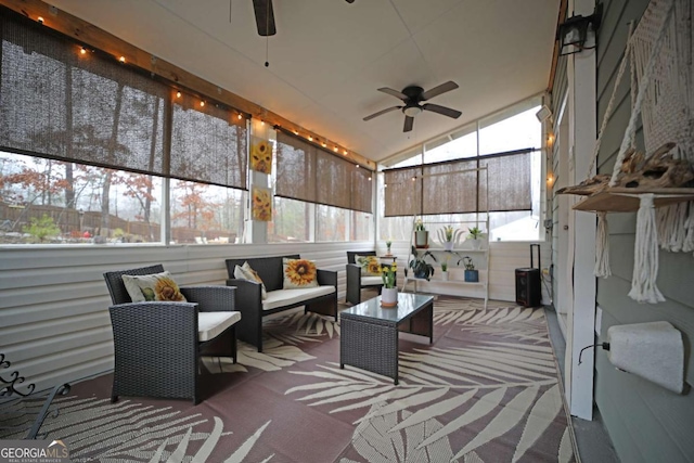 sunroom featuring lofted ceiling, plenty of natural light, and ceiling fan