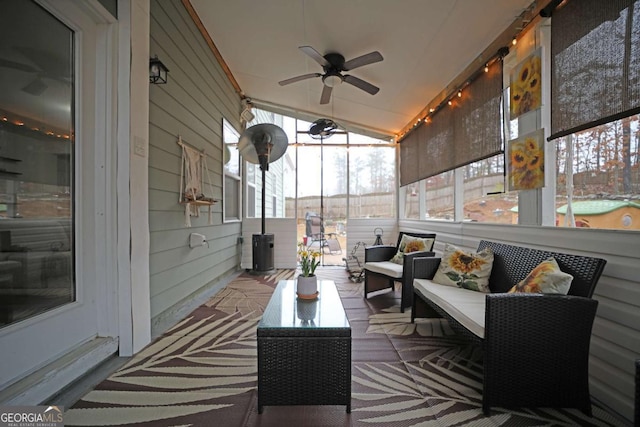 sunroom / solarium with lofted ceiling and ceiling fan