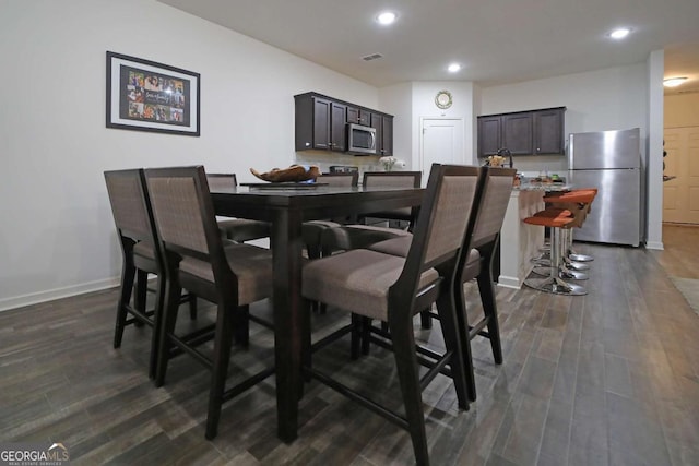 dining area featuring dark hardwood / wood-style floors