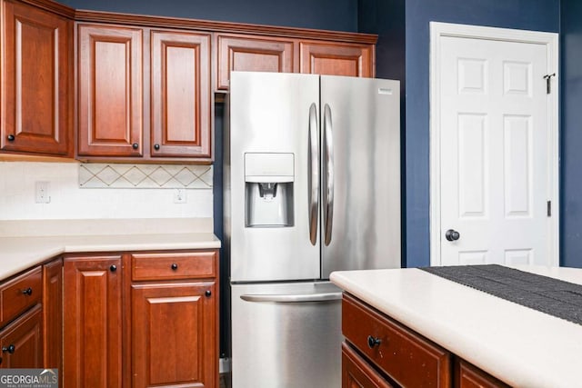 kitchen featuring stainless steel fridge with ice dispenser and backsplash