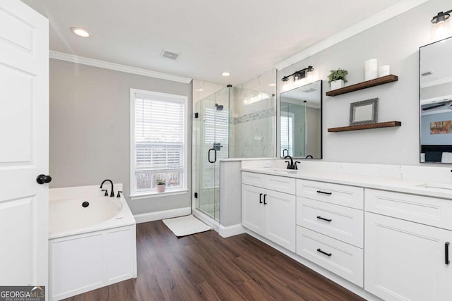 bathroom featuring hardwood / wood-style flooring, crown molding, separate shower and tub, and vanity