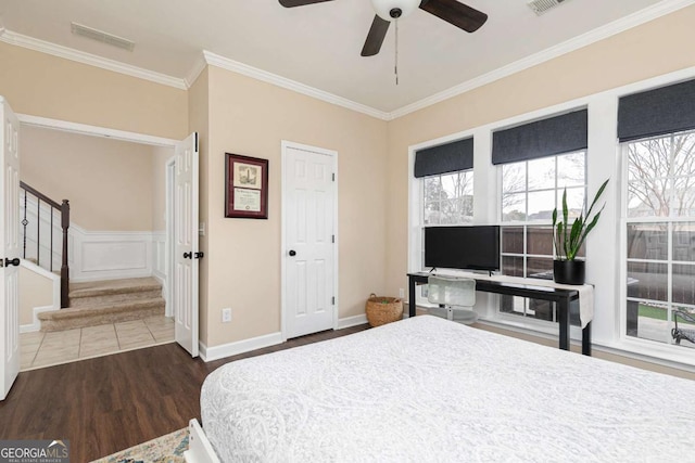 bedroom featuring ornamental molding, dark hardwood / wood-style floors, and ceiling fan