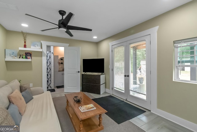 living room featuring french doors and ceiling fan