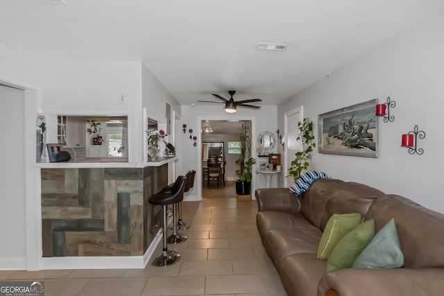 living room featuring tile patterned flooring and ceiling fan