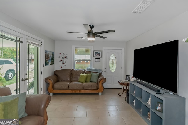 tiled living room featuring ceiling fan