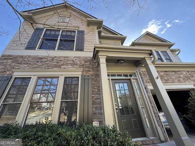 entrance to property featuring stone siding