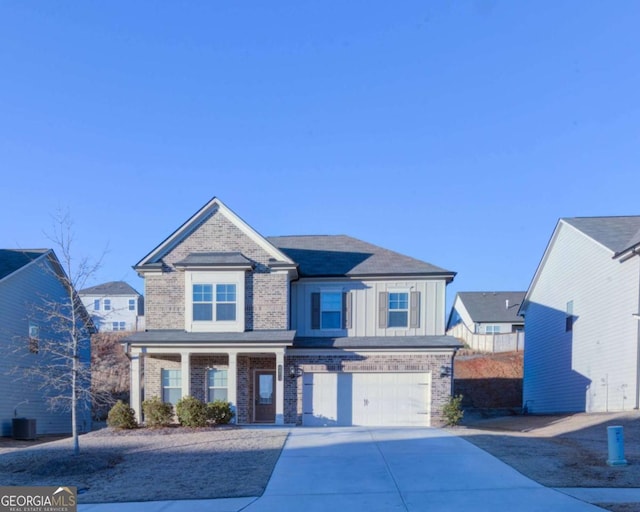 view of front of home featuring a garage and central AC