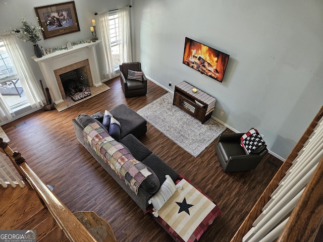 living room featuring a high end fireplace and wood-type flooring