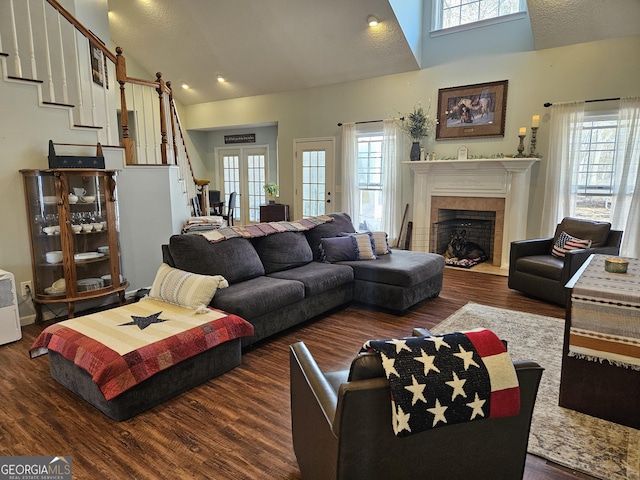 living room with french doors, dark hardwood / wood-style flooring, and high vaulted ceiling