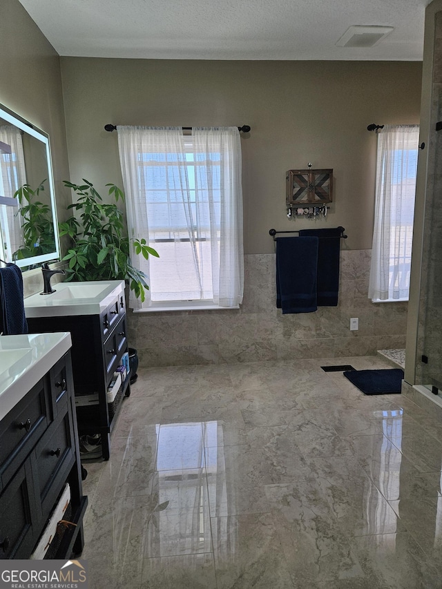 bathroom with vanity and tile walls