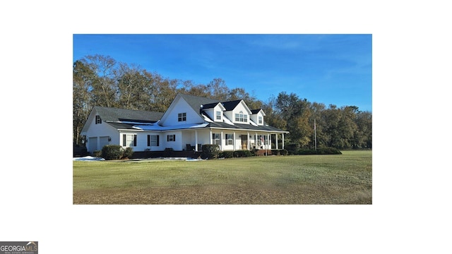 view of front of property with a garage, covered porch, and a front yard