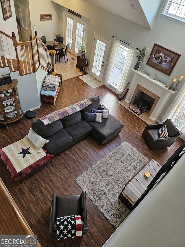 living room with a towering ceiling and hardwood / wood-style floors