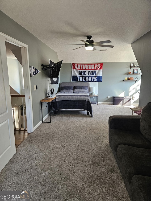 bedroom featuring ceiling fan, carpet, and a textured ceiling