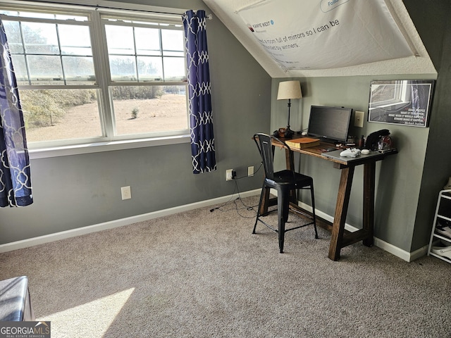 carpeted office featuring vaulted ceiling