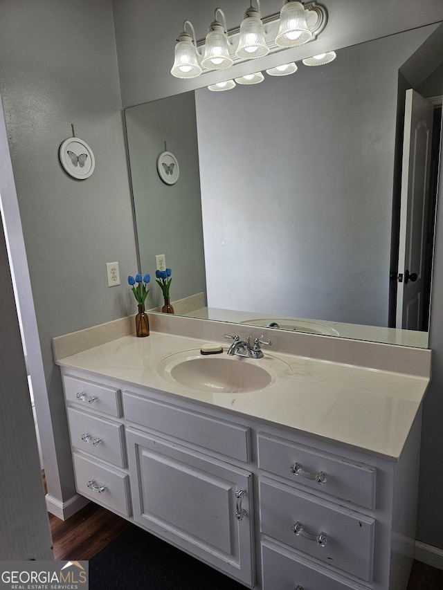 bathroom featuring hardwood / wood-style flooring and vanity