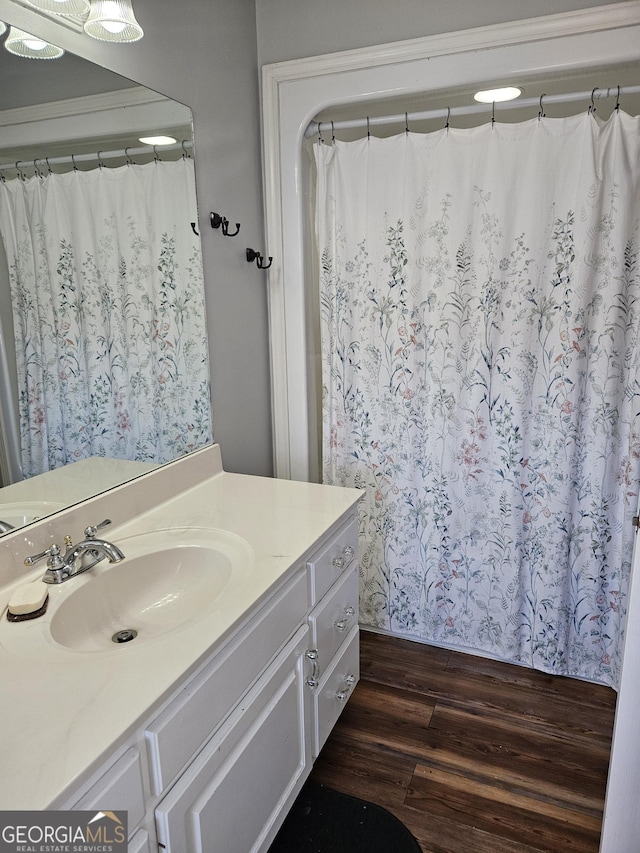 bathroom with vanity and wood-type flooring