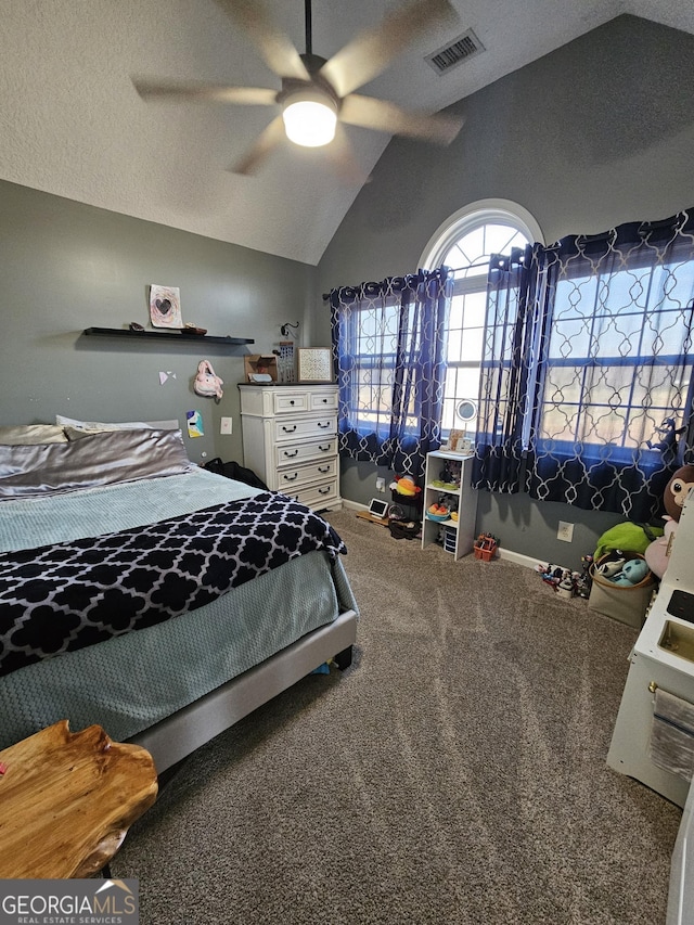 carpeted bedroom with ceiling fan, vaulted ceiling, and a textured ceiling