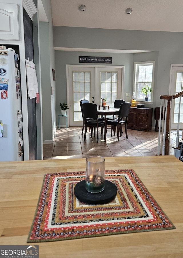 dining room featuring tile patterned floors and french doors