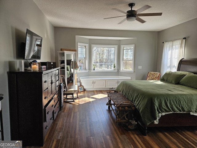 bedroom featuring a textured ceiling and dark hardwood / wood-style flooring