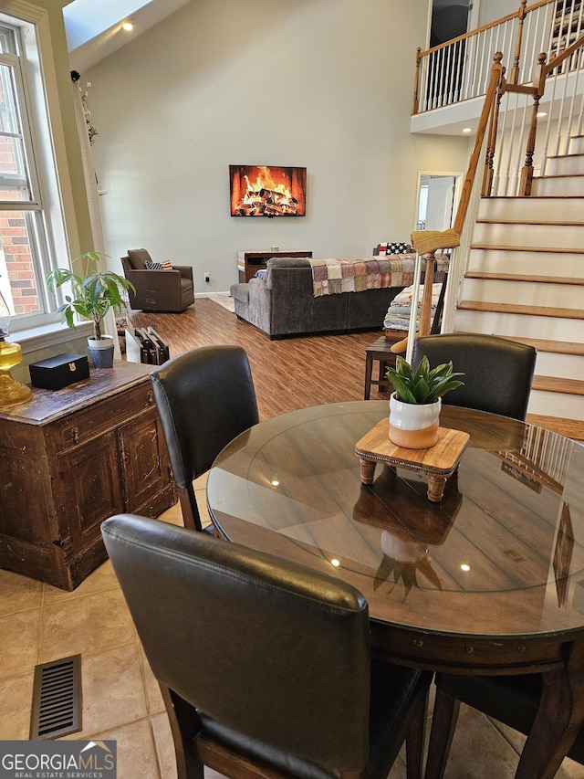 dining room featuring high vaulted ceiling