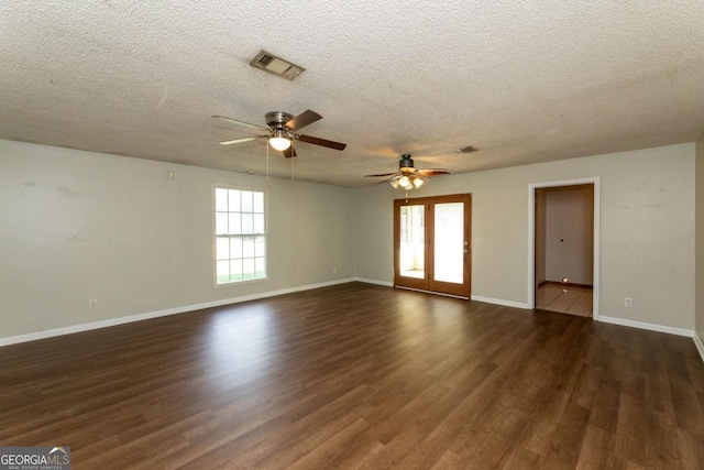 spare room featuring dark hardwood / wood-style flooring, a textured ceiling, and ceiling fan