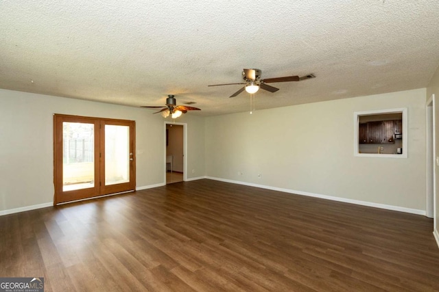 unfurnished living room with ceiling fan, a textured ceiling, and dark hardwood / wood-style flooring