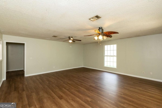 spare room with ceiling fan, dark hardwood / wood-style floors, and a textured ceiling