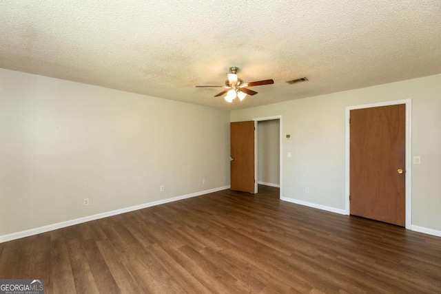 unfurnished bedroom featuring ceiling fan, dark hardwood / wood-style floors, and a textured ceiling