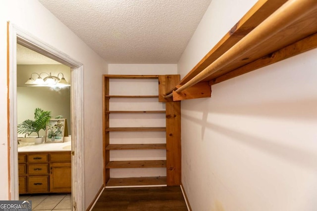 walk in closet with light tile patterned flooring