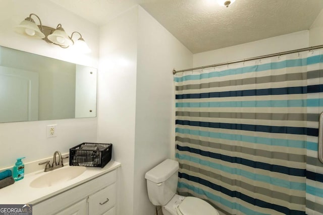 bathroom with a shower with curtain, vanity, a textured ceiling, and toilet