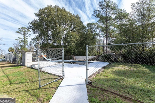 view of gate featuring a lawn