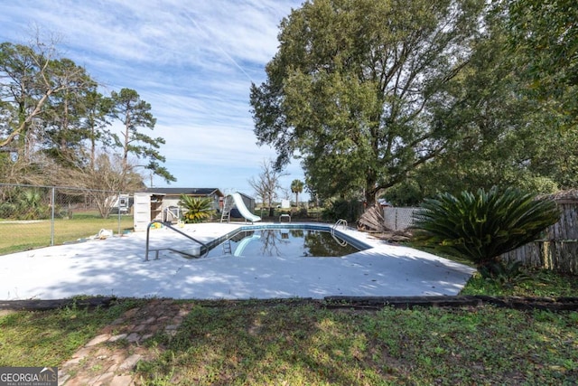 view of yard with a fenced in pool and a patio