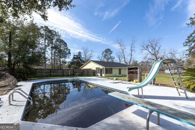 view of swimming pool featuring a water slide and a patio area