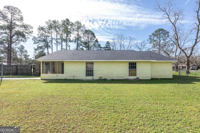 view of front facade with a sunroom and a front yard