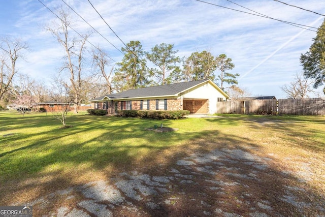 ranch-style house featuring a garage and a front lawn