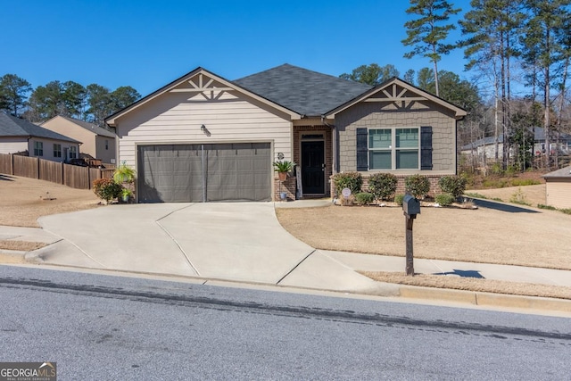 craftsman-style house with driveway, an attached garage, and fence