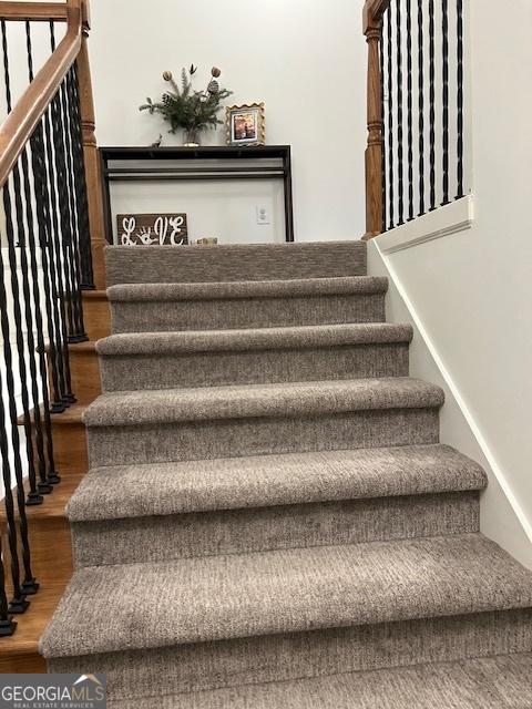 stairway featuring wood finished floors