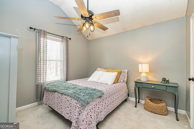 carpeted bedroom with ceiling fan and lofted ceiling