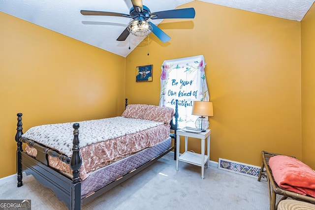 carpeted bedroom featuring lofted ceiling, a textured ceiling, and ceiling fan