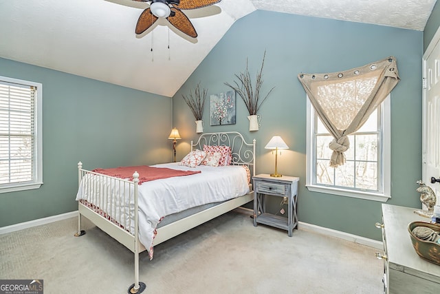 carpeted bedroom with ceiling fan and lofted ceiling