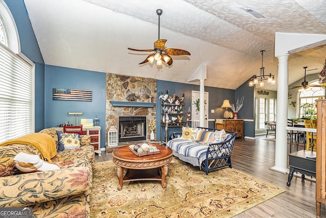 living room featuring ornate columns, vaulted ceiling, and ceiling fan