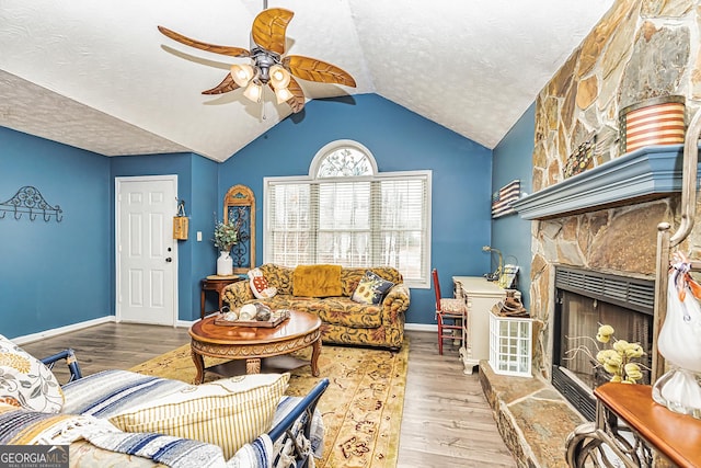 living room featuring hardwood / wood-style flooring, a textured ceiling, and a fireplace