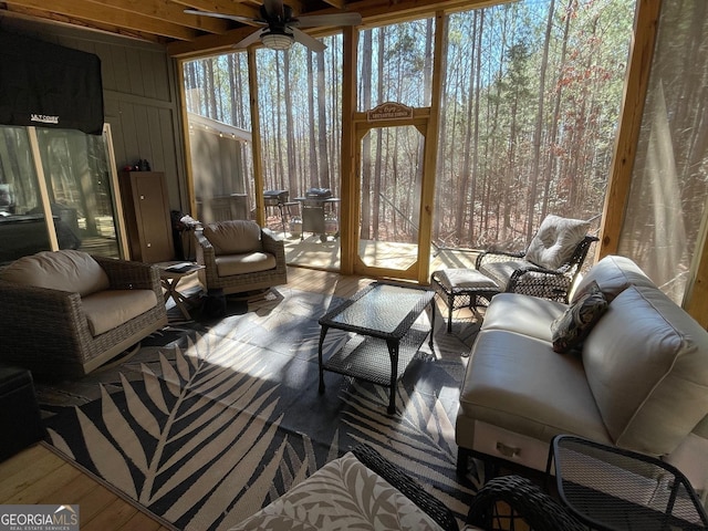 sunroom / solarium featuring ceiling fan