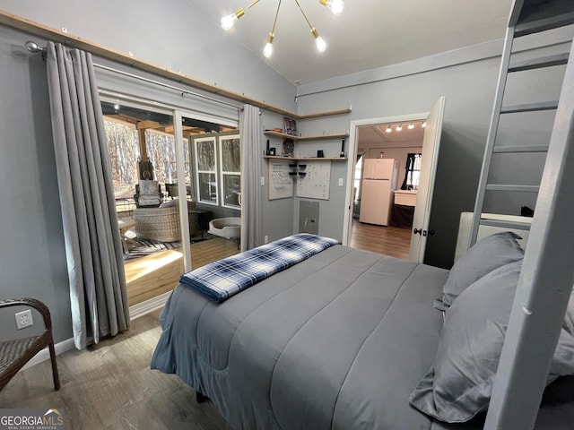 bedroom featuring hardwood / wood-style flooring, lofted ceiling, and white fridge