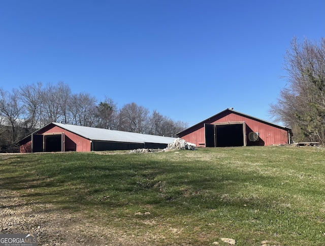 view of outbuilding featuring a yard