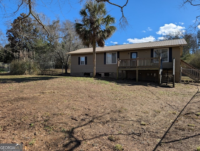 rear view of property featuring a deck