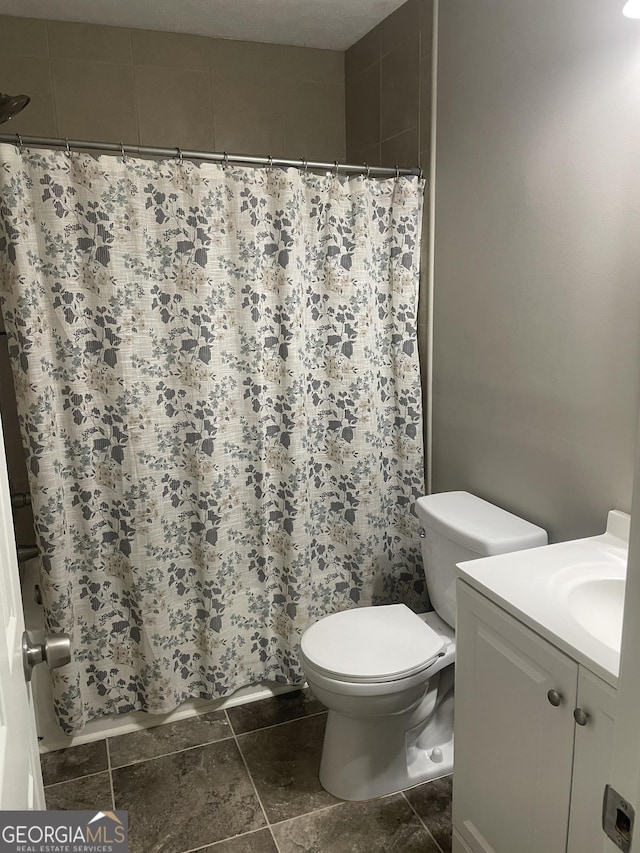 bathroom with toilet and vanity